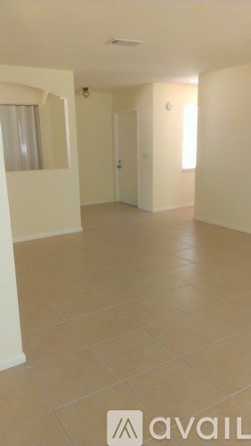 A room with tiled flooring and white walls.
