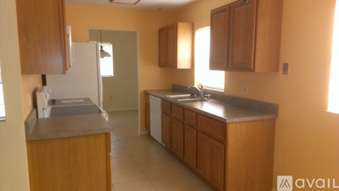 A kitchen with wooden cabinets and a white refrigerator.