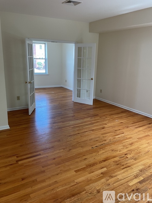 A room with wooden floors and white walls.