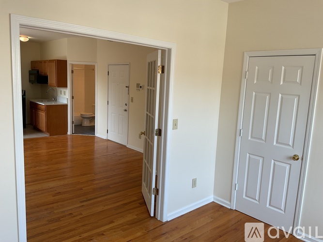 A room with a white door and a white wall.