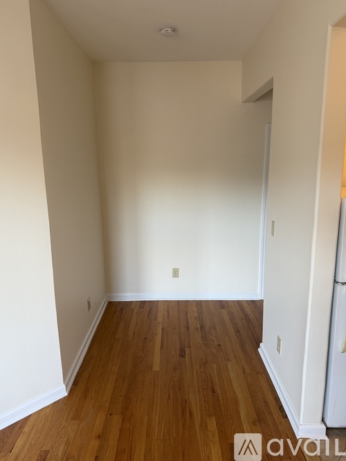A room with wooden floors and white walls.