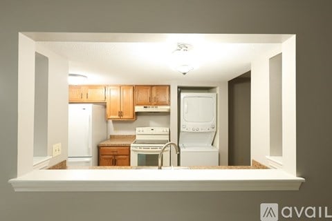 A kitchen with wooden cabinets and white appliances.