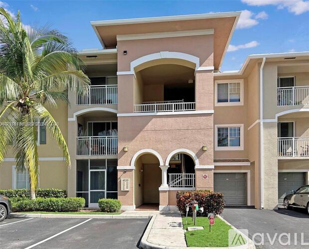 A multi-story apartment building with a balcony on the second floor.