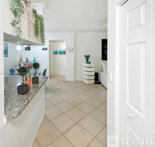 A kitchen with a granite countertop and a white door.