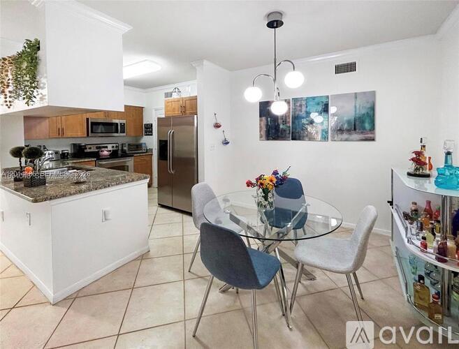 A kitchen with a dining table and chairs.
