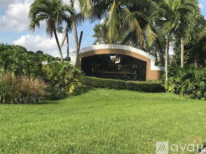 A building with a curved roof is surrounded by greenery.