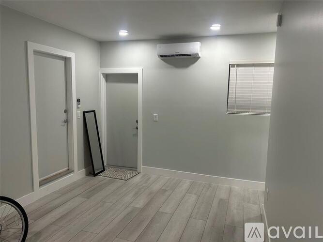 A room with a bicycle leaning against the wall.
