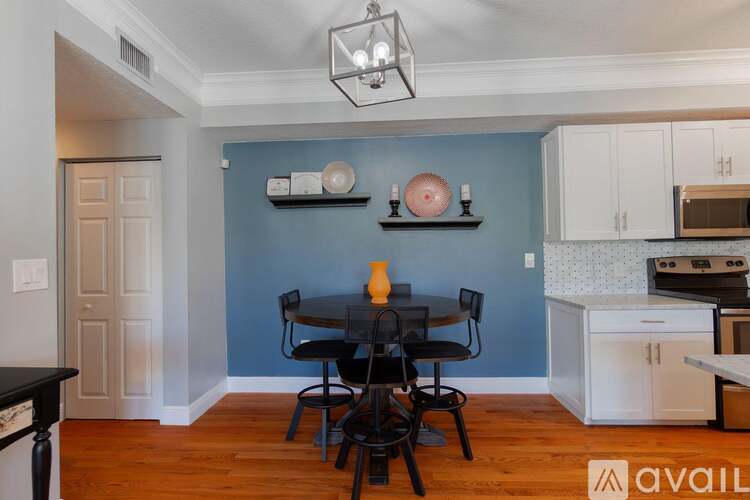 A kitchen with a table and chairs in the middle of the room.
