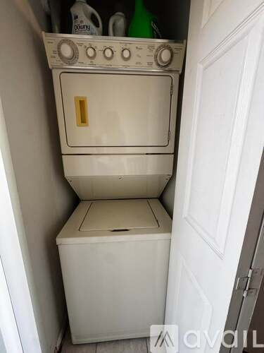 A white oven and drawer are in a small kitchen.