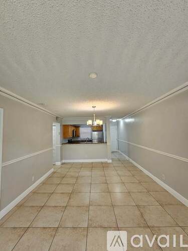A long hallway with tiled floors and white walls.