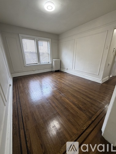 A room with wooden floors and white walls.