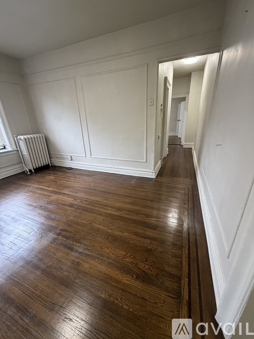 A room with wooden floors and white walls.