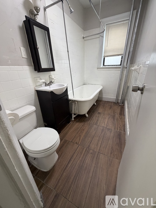 A bathroom with a white toilet, sink, and bathtub.