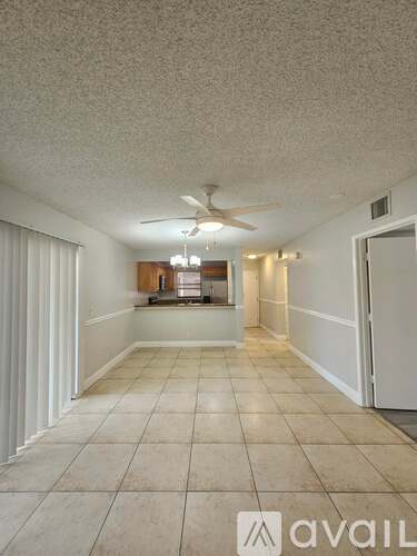 A room with a fan and a light on the ceiling.