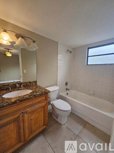 A bathroom with a toilet, sink, and tub.