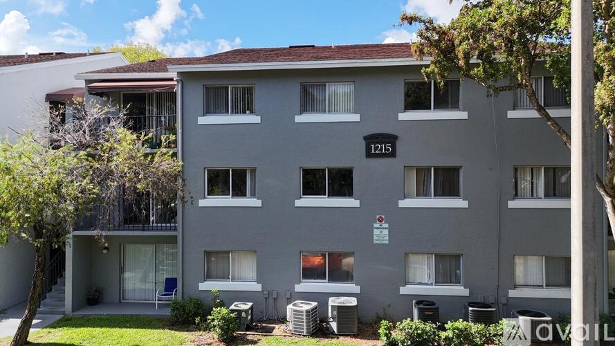 A grey apartment building with the number 1215 on the front.