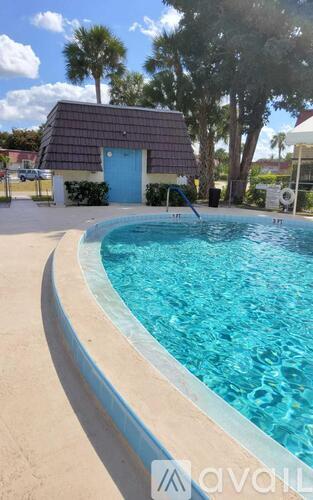 A pool with a blue door in the background.