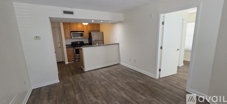 A kitchen area with a refrigerator, microwave, and oven.