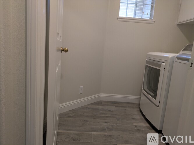 A kitchen area with a white oven and a window.