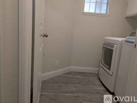 A kitchen area with a white oven and a window.