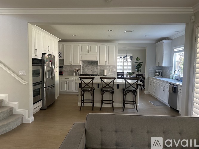 A kitchen with a table and chairs in the middle of the room.