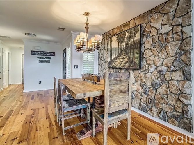 A dining room with a wooden table and chairs.