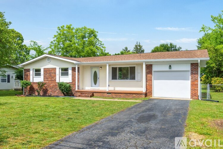 A two-story house with a garage is for sale.