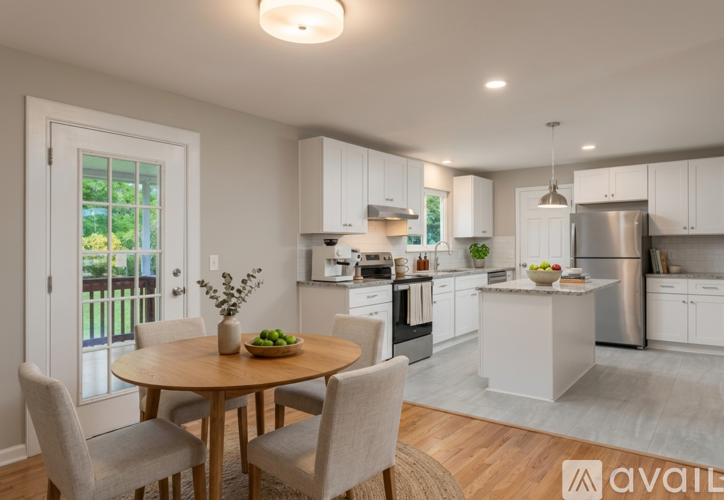 A modern kitchen with a dining table set for four.