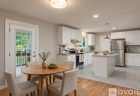 A modern kitchen with a dining table set for four.