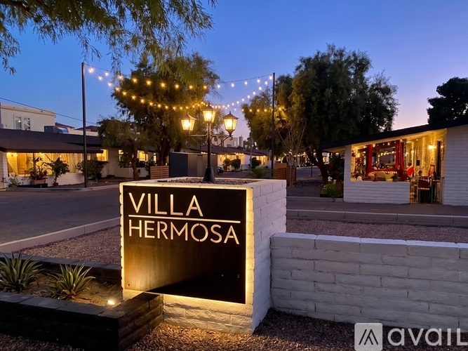 A sign that says Villa Hermosa in front of a building.