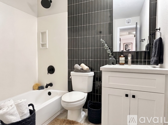 A bathroom with a white toilet, a white sink, and a white bathtub.