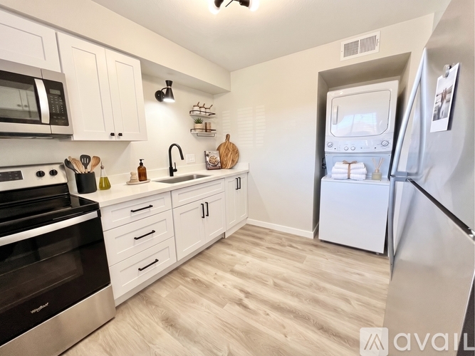 A kitchen with white cabinets and a black stove top oven.