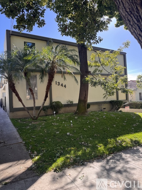 A building with the number 1344 on it is surrounded by trees.
