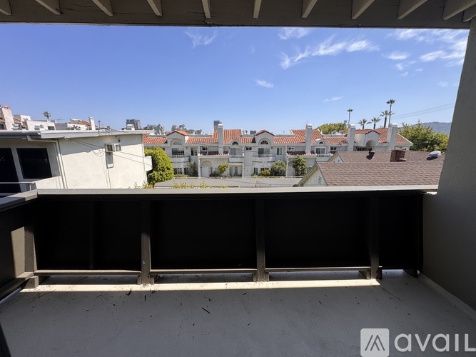 A balcony with a view of a residential area.