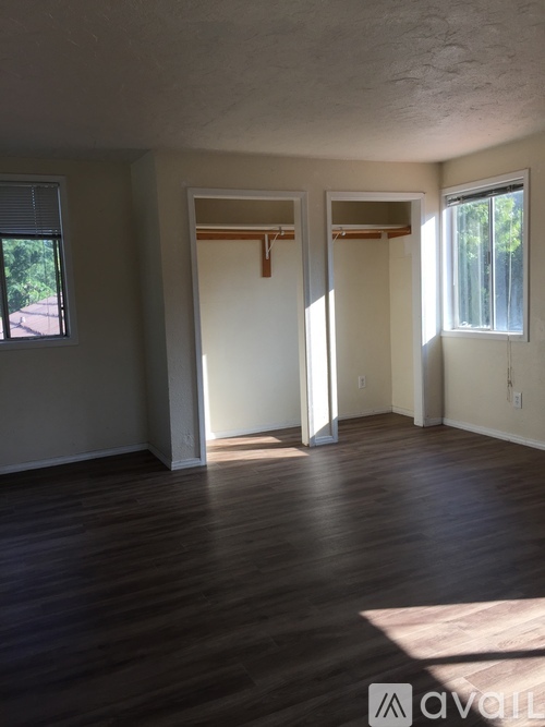 A room with wooden floors and white walls.