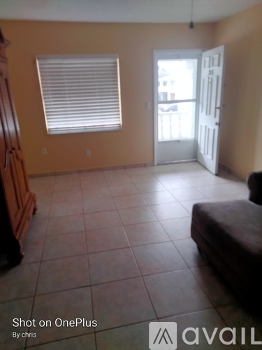 A room with a brown sofa and a white door.