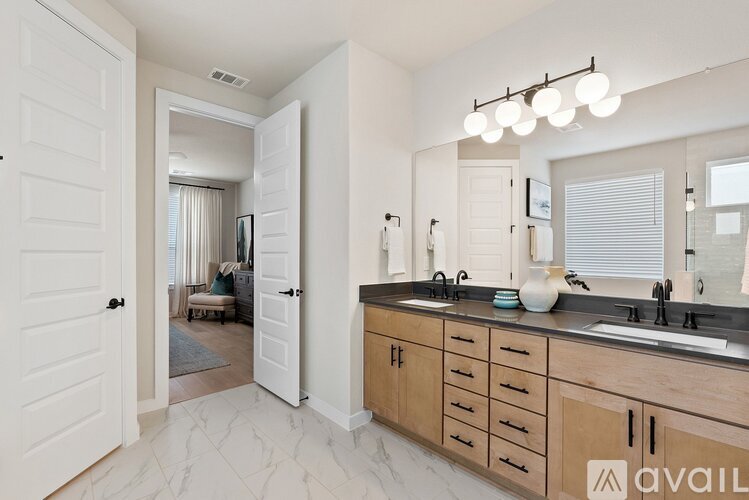 A modern kitchen with wooden cabinets and a marble floor.