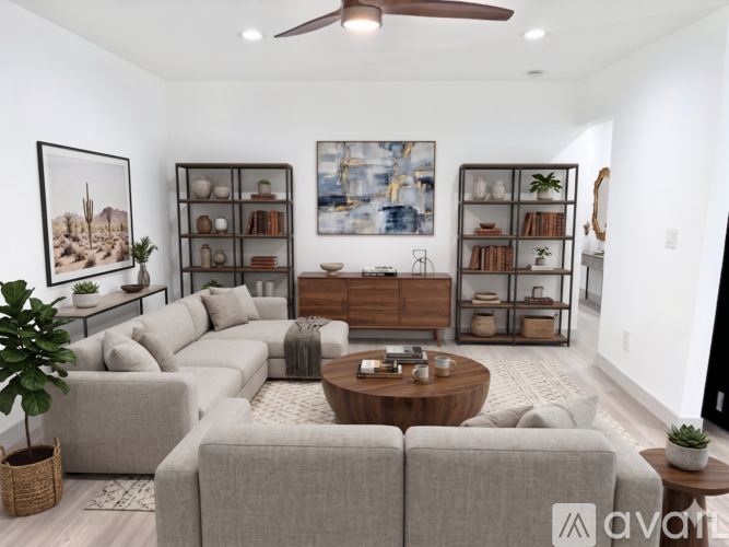 A living room with a grey sofa set, a wooden coffee table, and a painting on the wall.