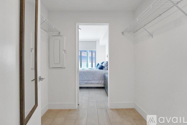 A bedroom with a bed and a window.