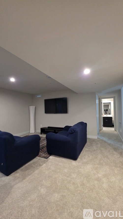A living room with a blue sofa and a television.