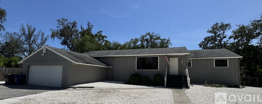 A house with a garage and a flag on the front.