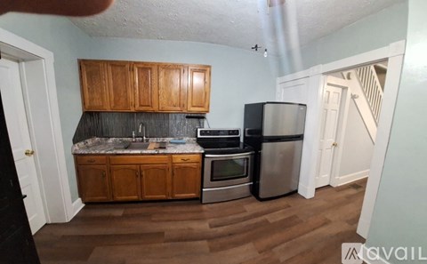 A kitchen with wooden cabinets and stainless steel appliances.