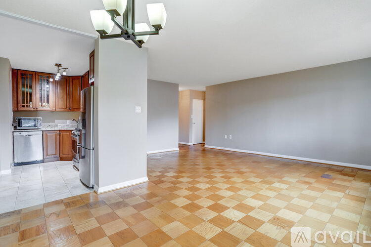 A kitchen with wooden cabinets and a checkered floor.