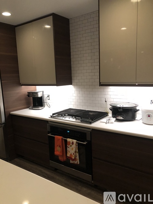 A kitchen with a stove top oven and a coffee maker.