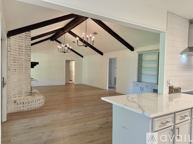 A spacious kitchen with wooden floors and a central island.
