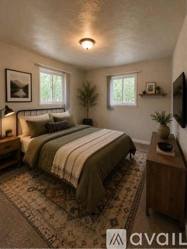 A bedroom with a bed, nightstand, and a television.