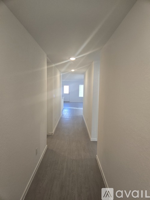 A long hallway with a light at the end.