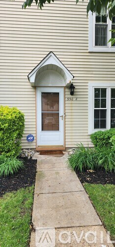 A house with a white door and a window is shown.