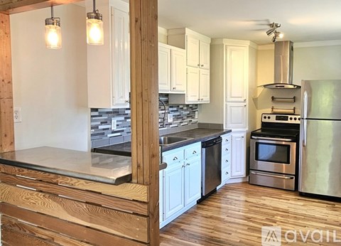 A kitchen with wooden cabinets and stainless steel appliances.