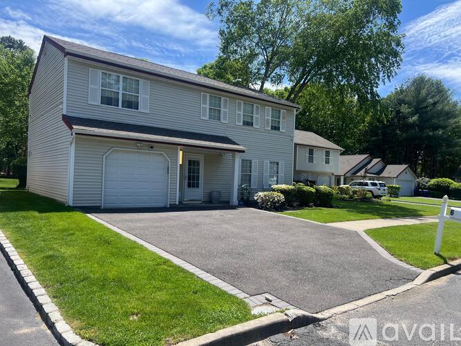 A two-story house with a garage is available for sale.